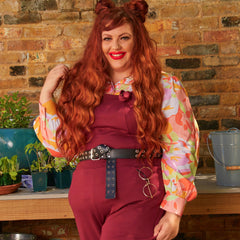 Woman wearing burgundy dungarees