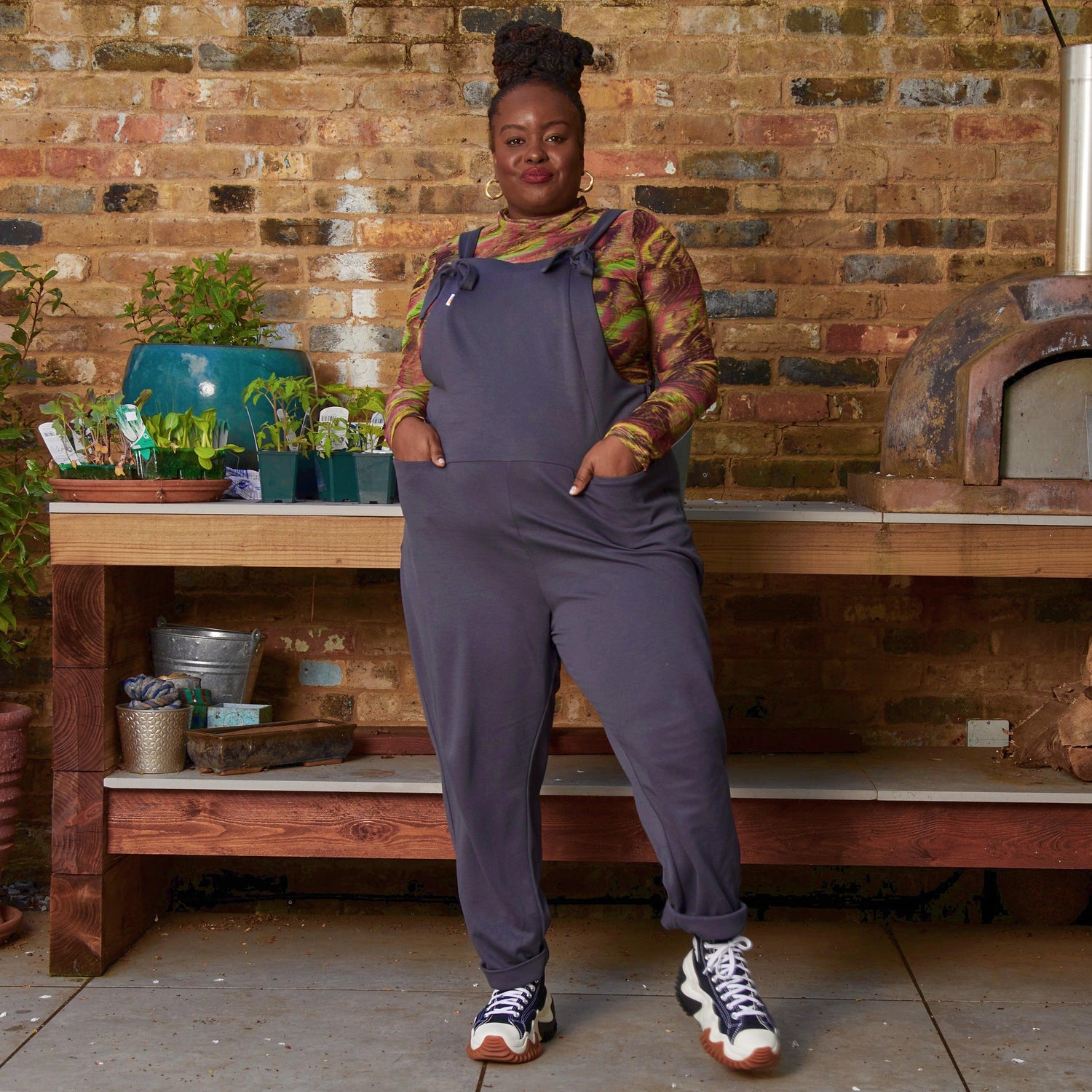 Woman wearing slate grey dungarees