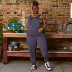 Woman wearing slate grey dungarees